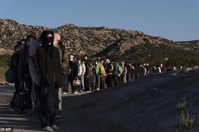 Chinese migrants await processing after crossing the border into Mexico on Wednesday, May 8, 2024, near Jacumba Hot Springs, California.  San Diego became the busiest corridor for illegal crossings in April, according to U.S. government data