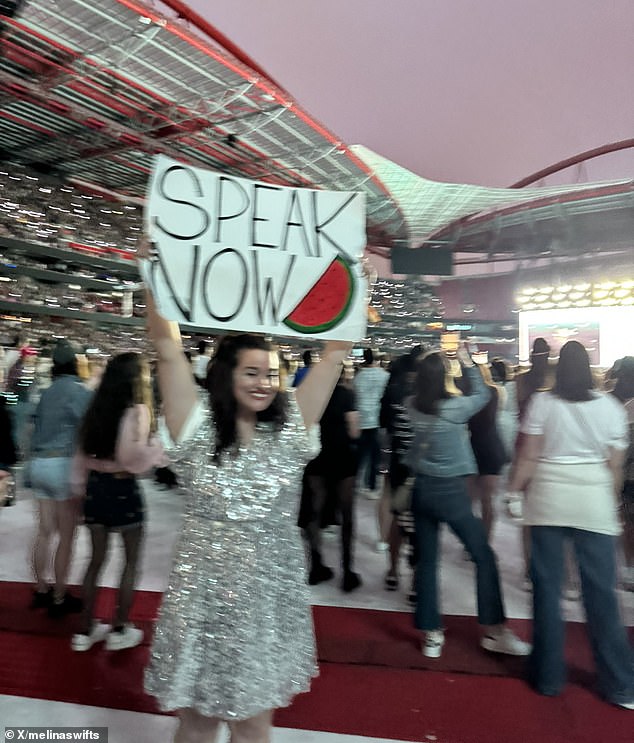 A concertgoer in a glittery dress held up a sign saying 'speak now' with a watermelon - a symbol of Palestinian solidarity