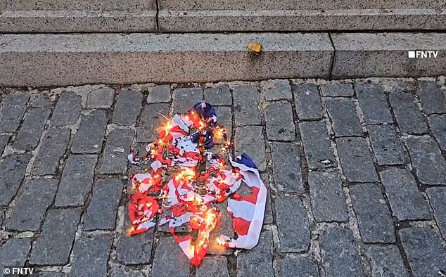 An American flag was left burning on the ground as chants of “Free Palestine” rang out