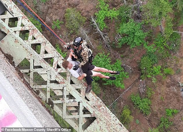 A rescue worker attached the man to a harness and brought him to safety