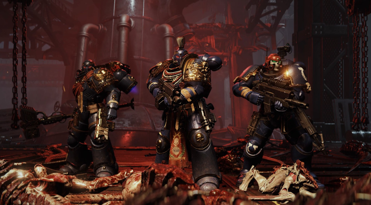 A team of three Space Marines for the game's co-op mode, each wearing custom armor with different equipment.