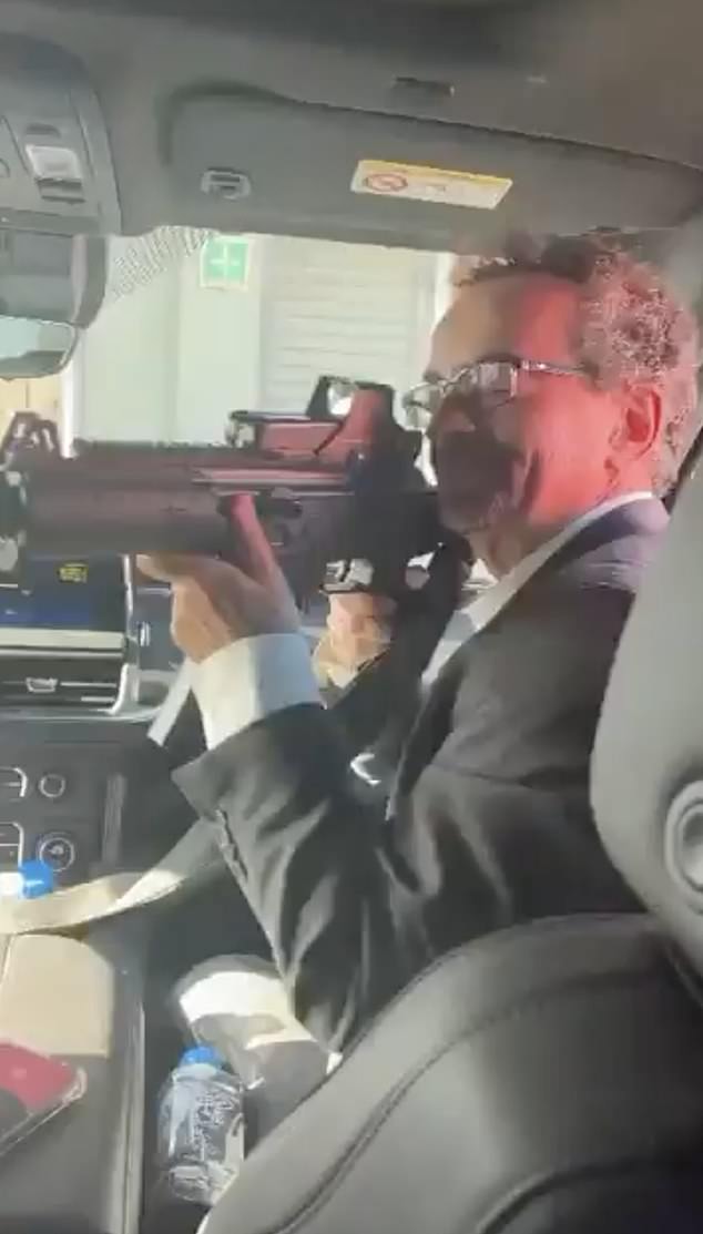 In the five-second clip, Jon Benjamin (pictured) is seen pointing the gun while sitting in the front seat of a car as music and laughter can be heard.