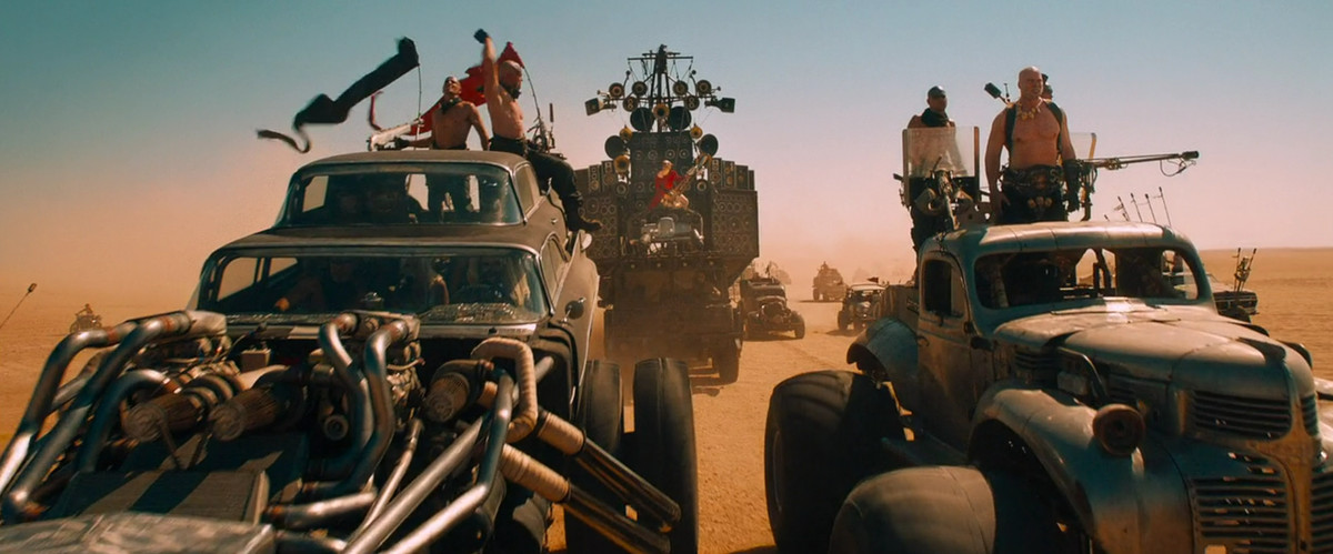 The Doof Warrior's Doof Wagon flanked by two other Immortan Joe vehicles in Mad Max: Fury Road