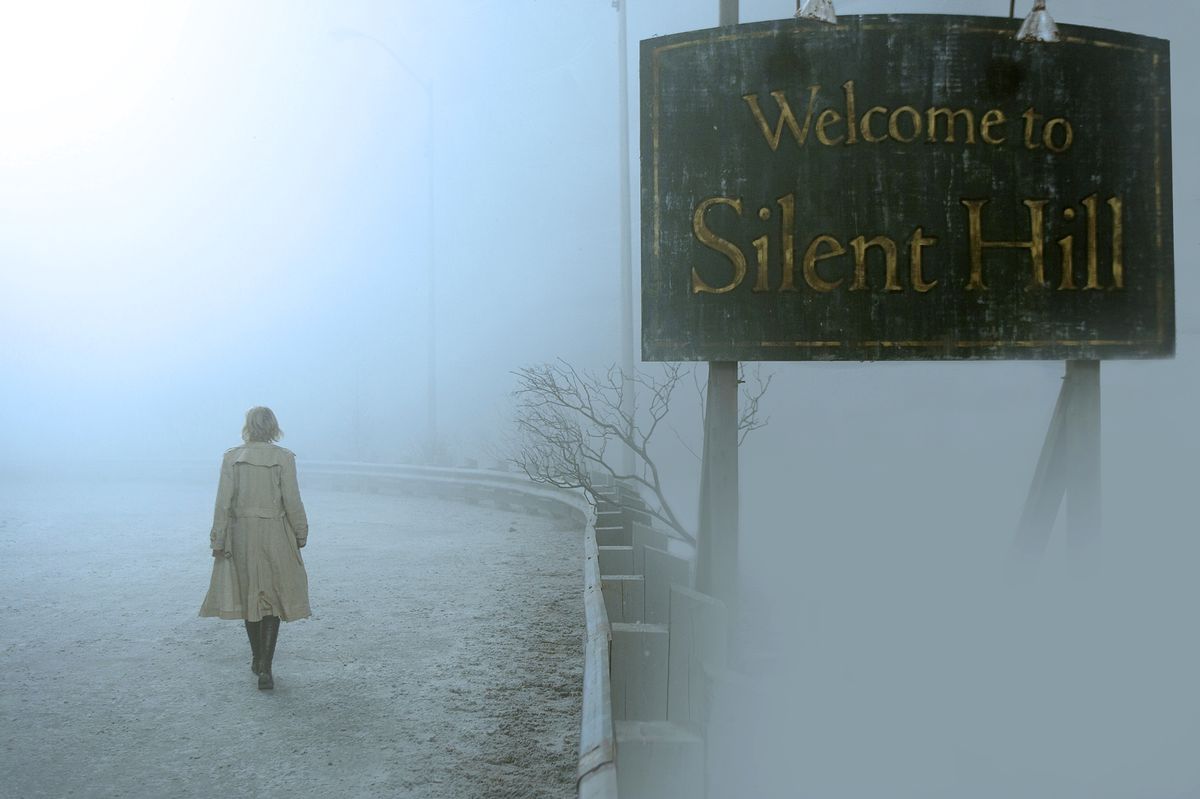 A still from the film Silent Hill with the 'Welcome to...' sign shrouded in mist