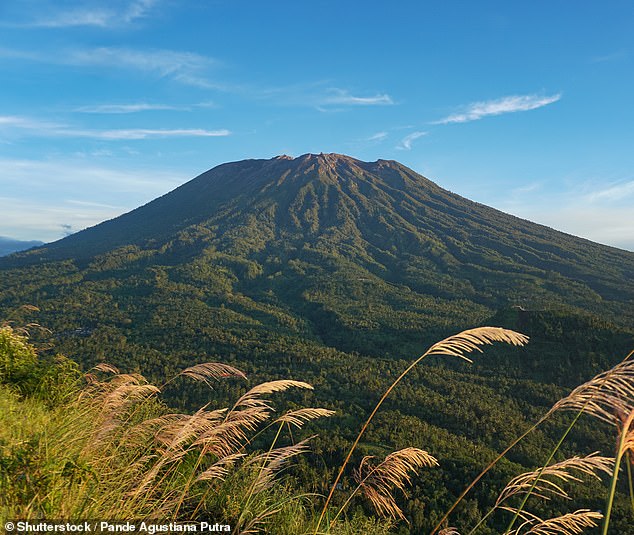 Holidaymakers in Bali have been urged to hire a local guide before attempting to climb the Indonesian island's mountains after two tourists died on Mount Agung (pictured)