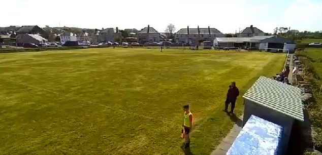 Footage shows the linesman and Amlwch staff crossing paths on the touchline in the first half