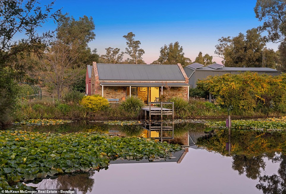 Nestled on a leafy estate in rural Victoria, a pretty stone cottage sits on the edge of a pond filled with water lilies that looks like something out of a Claude Monet painting