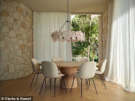 Guests are led through the front door past a sunken garden, where they are greeted by a formal dining room beneath a soaring 12-foot ceiling