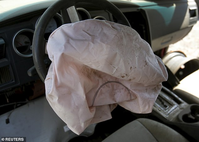 A deployed Takata-manufactured airbag is seen on the driver's side of a 2007 Dodge Charger in a recycled car parts lot in Detroit