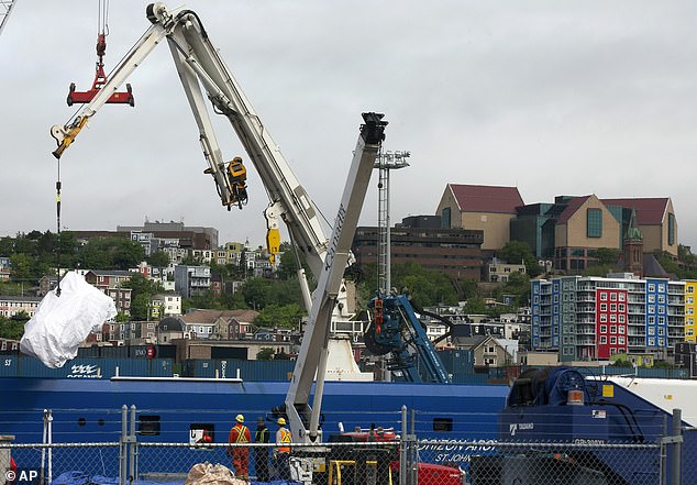 Debris from the Titan submarine, recovered from the ocean floor near the wreck of the Titanic, is unloaded from a ship