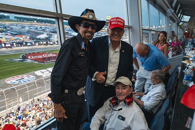 Trump posed during the race next to former American racing driver Richard Petty (left).