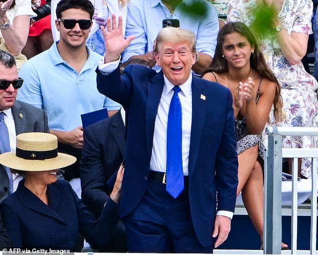 Former President Donald Trump waves as he attends the graduation ceremony of his son, Barron Trump, at the Oxbridge Academy in Palm Beach, Florida on May 17, 2024