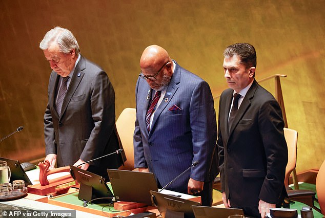 UN Secretary General Antonio Guterres (L) stands during a moment of silence during a United Nations (UN) General Assembly tribute to the late Iranian President Ebrahim Raisi at UN Headquarters in New York on May 30, 2024