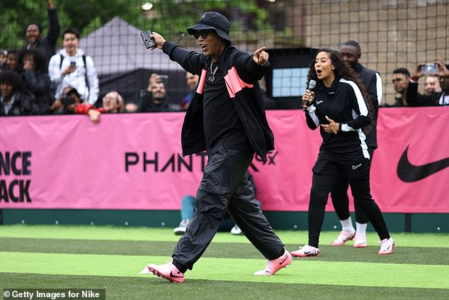 Ronaldinho raced to celebrate with a young footballer after they had taken the top corner