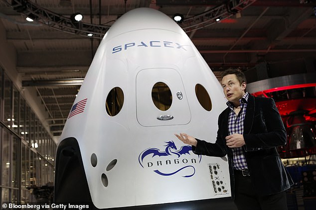 SpaceX boss Elon Musk is pictured with the company's Crew Dragon spacecraft.  NASA hopes to certify Boeing's Starliner as a second 'taxi' service for its astronauts to the ISS - a role SpaceX has held since 2020