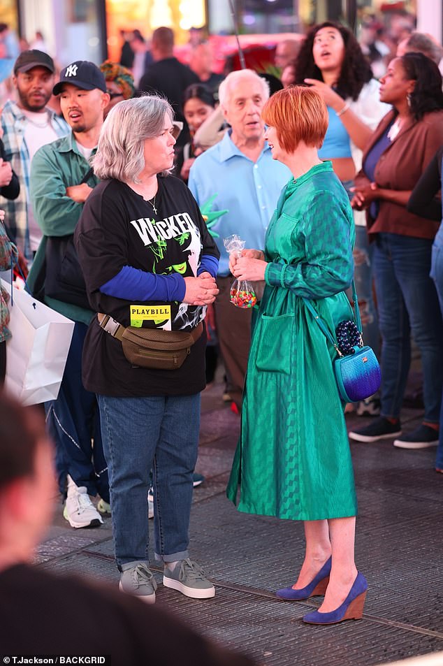 She also wore an iridescent crossbody bag with a mix of the same colors from both her dress and her shoes.