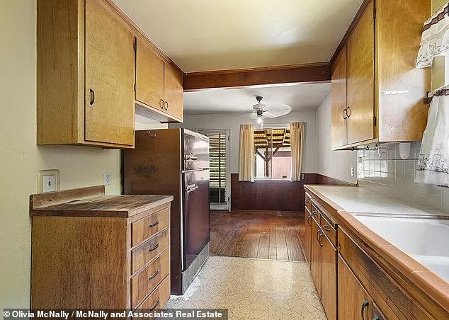 The 'fixer-upper' includes an open kitchen and living room, but the new owners may want to give it a renovation