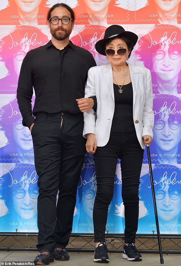 Yoko Ono and Sean Lennon stand next to the 2018 John Lennon postage stamp design dedication ceremony in New York