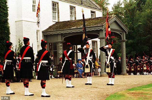 The Queen Mother watches the ceremony where she presented the 1st Battalion, The Black Watch, with new colours, at Birkhall