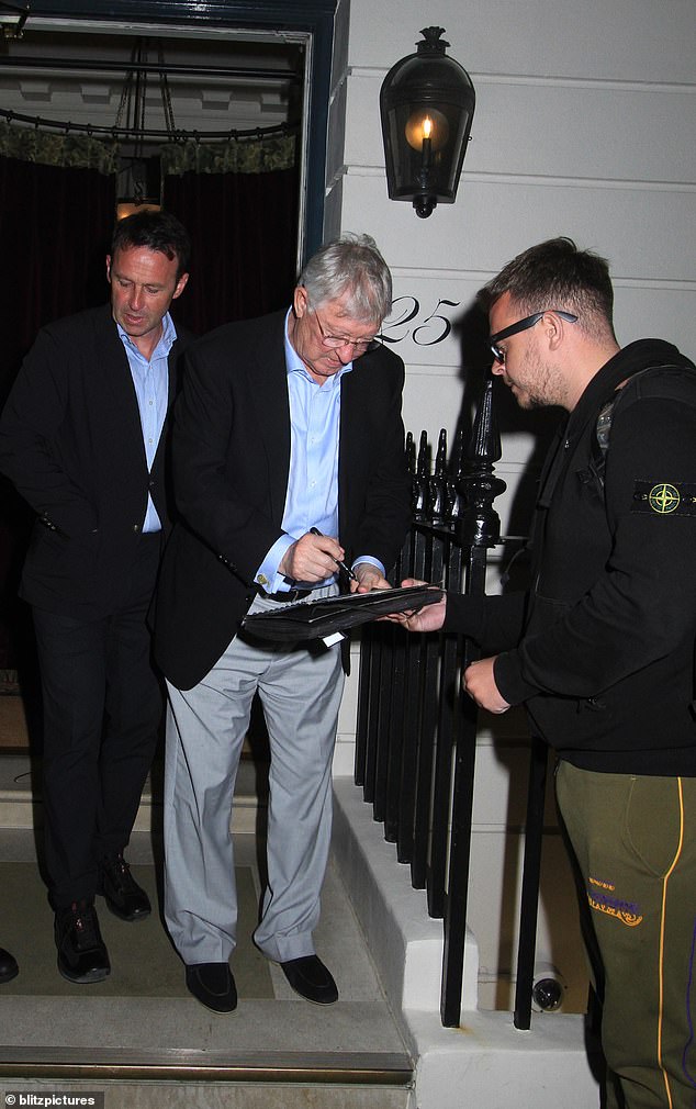 Ferguson stopped in front of fans and signed autographs while accompanied by Dougie Freedman