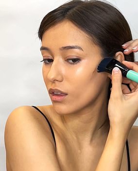 Use a short, flat, dense, rectangular chisel brush, which allows you to apply the product directly into the cheekbones and drag it upwards, towards the side of your face.  Make sure you concentrate the product on the outside of your face, higher up on the hand guide you did before applying, rather than closer to the lips