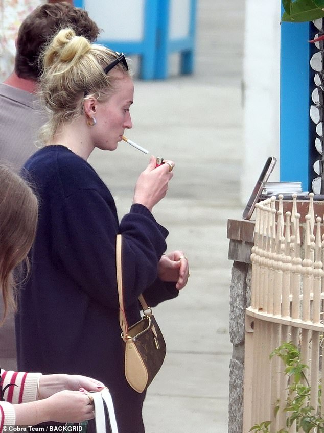 The star was also seen puffing on a cigarette as she embraced her natural beauty and appeared makeup-free for the outing