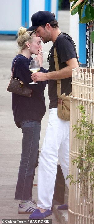 Keeping it classy, ​​Sophie opted for a simple navy blue sweater and straight-leg jeans, as she rested her sunglasses on her head