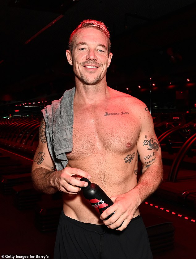 While heading to his treadmill run, Diplo took off his shirt, revealing his toned abs and multiple tattoos.