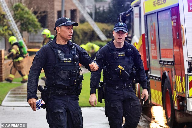 Police (pictured at the scene on Saturday) announced that the search area is now a crime scene and that officers have closed the street