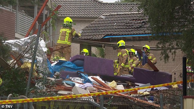 Emergency services (pictured) braved heavy rain and cold and worked overnight in a bid to find the woman trapped under the rubble