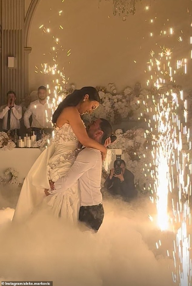 Images shared on Instagram capture the magical moment the couple share a romantic dance surrounded by a cloud of mist, with Aleksandra holding a bouquet of white flowers