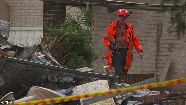 Rescuers (pictured) are still searching for the woman after firefighters heard 'cranes' and sounds coming from under the rubble of the collapsed building, which they say is a sign the woman is still alive.