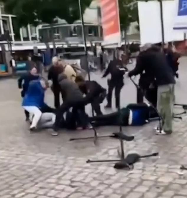 Other footage captured the moment German officers knocked a man to the ground after mistaking him for the attacker during a horror stabbing in Mannheim, Germany