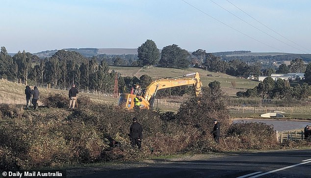 An excavator was used on Wednesday to clear blackberry bushes next to the dam