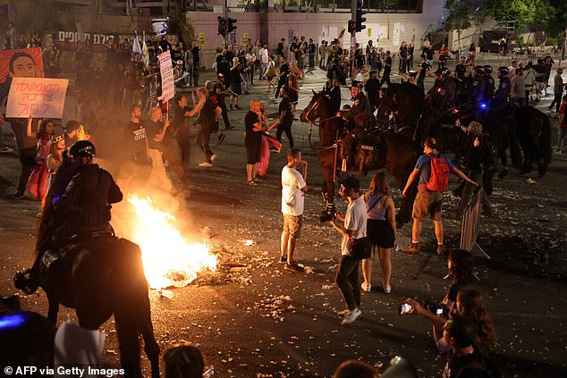 Israeli mounted police try to disperse a demonstration of relatives and supporters of Israelis being held hostage by Palestinian Hamas militants in Gaza