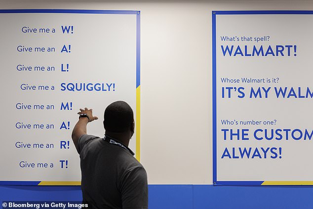 Walmart executive Greg Harden gestures to a sign during a meeting at his Dallas store, where he oversees about $100 million in annual sales