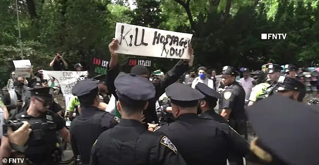 Officers were seen trying to stop the vicious protester, who was wearing a mask to hide his face