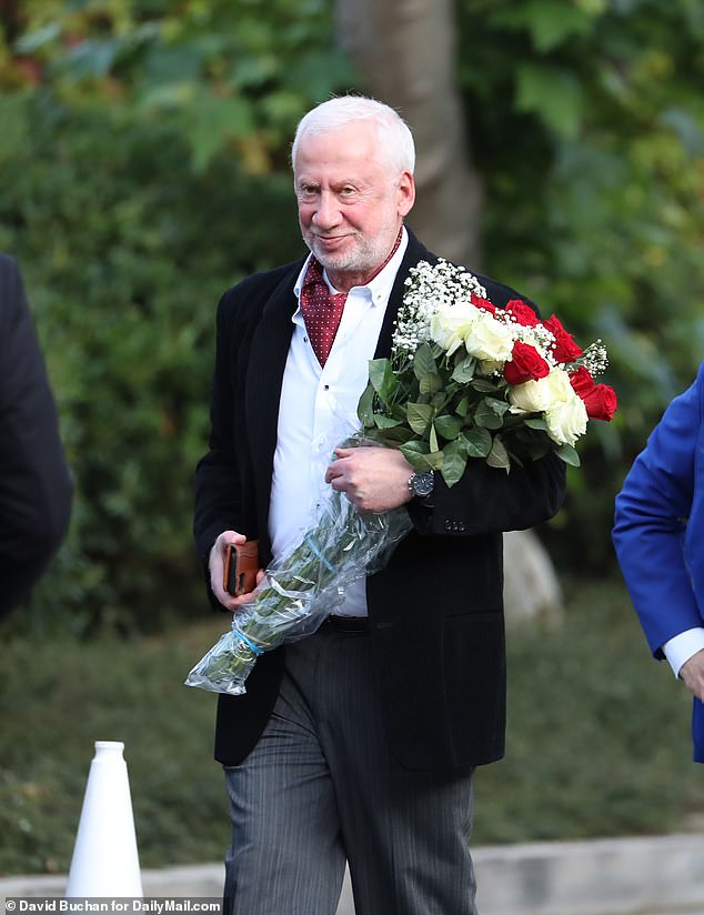 A guest arrives at Rupert Murdoch's home for his wedding to Elena Zhukova