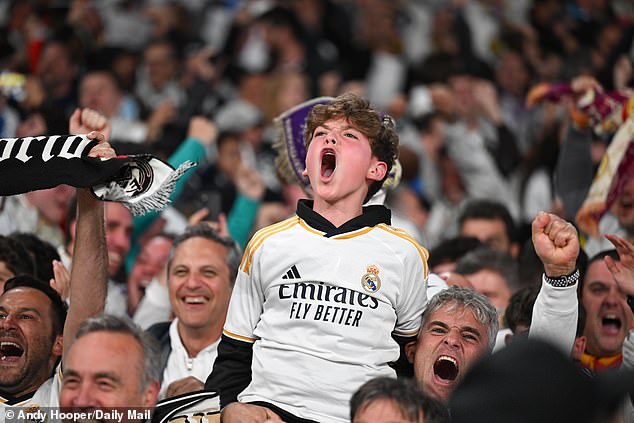A young Madrid fan screams with joy after seeing his team win another Champions League trophy