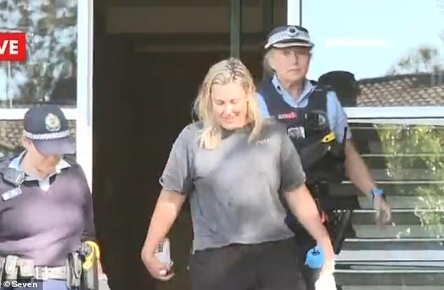 Donlan is pictured with police at the time of her arrest in June 2023