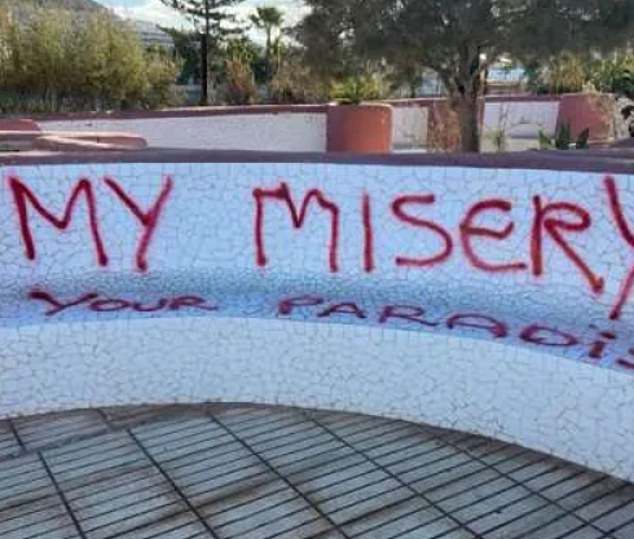 Graffiti can be seen in the Balearic Islands with the text 'My misery, your paradise'