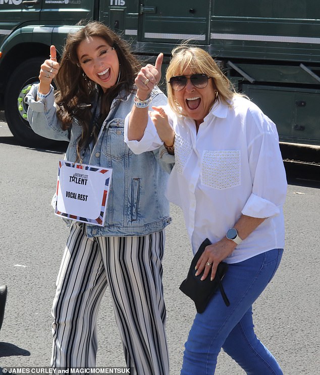 Budding West End star Sydnie Christmas, 28, had a sign around her neck saying she was on vocal rest, but that didn't dampen her mood as she threw her thumbs in the air