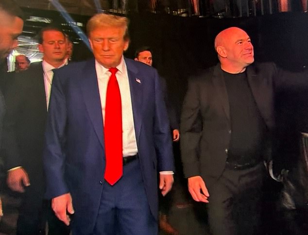 Trump (left) walked into the Prudential Center on Saturday with UFC CEO Dana White (right).