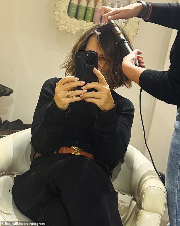 The frame shows Lisa taking a cheeky selfie in a salon as a stylist with 'magic hands' expertly curls her freshly cut, shaggy locks which are now shoulder length.  Lisa's comments left no doubt that the veteran television star was very pleased with the results