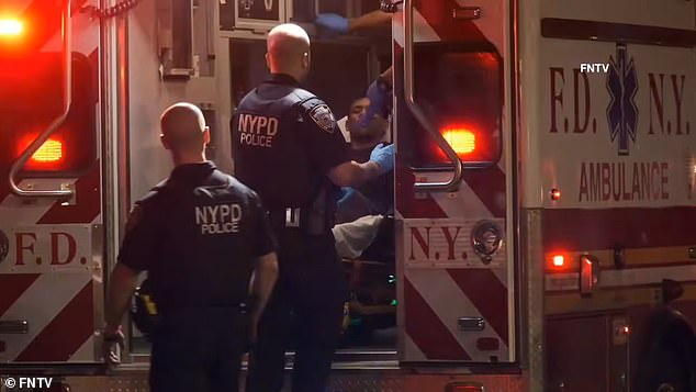 An illegal Venezuelan migrant has been arrested for allegedly shooting two NYPD officers while riding a scooter after they tried to stop him, officials said.  (Image: Castro-Mata being taken away from the scene of the shooting on a stretcher)