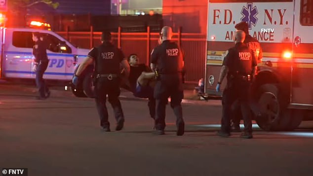 Another image shows three officers carrying Castro-Mata away from the crime scene in East Elmhurts, Queens, by his arms and legs as he grimaces