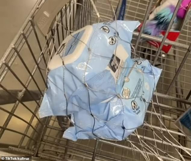 The makeup wipes a Walmart customer puts in her shopping cart are wrapped in metal wire to prevent theft