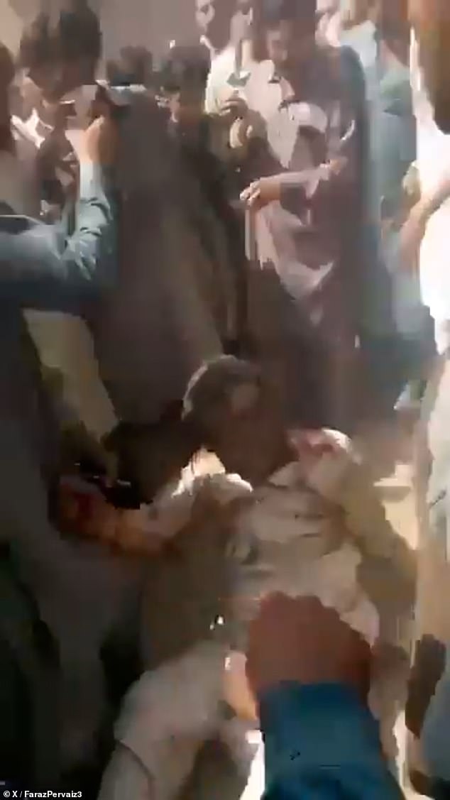 Horrifying footage shows Masih surrounded by a surging crowd as a gaping wound on his head bleeds and he appears barely conscious