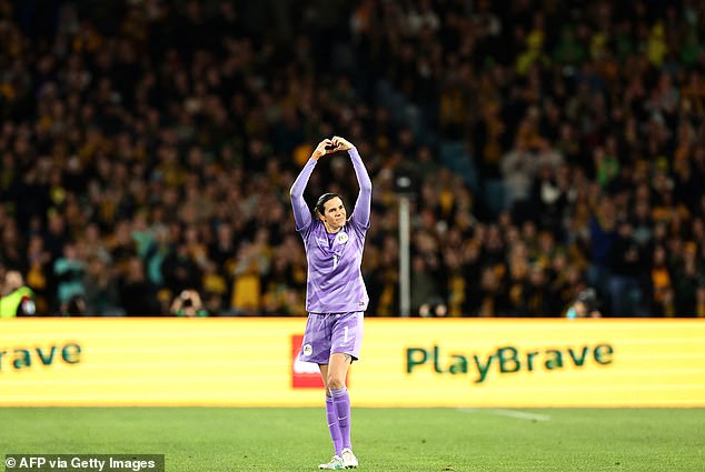 Williams shows a love heart symbol to the thousands of Australian supporters who came to watch the match and honor her last game for her country