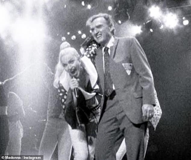 In another photo, a young Madonna stood on stage with her beaming father at an old concert